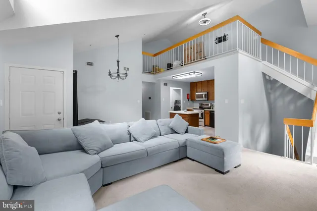 a living room with furniture and a baby crib