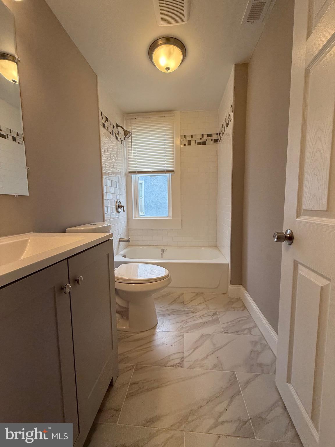 14 Franklin Street Frederick, MD 21701 - Photo 13 of 26 a bathroom with a sink a toilet and shower