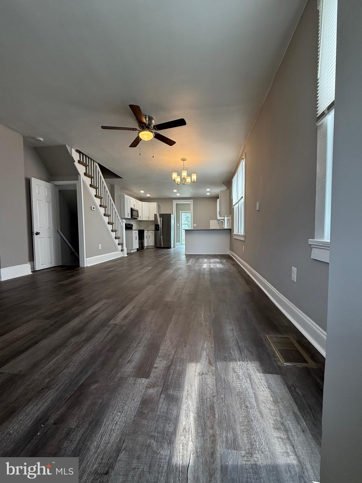 14 Franklin Street Frederick, MD 21701 - Photo 2 of 26 a view of an empty room with wooden floor and a ceiling fan