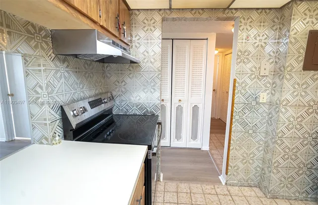 a kitchen with a stove and a refrigerator