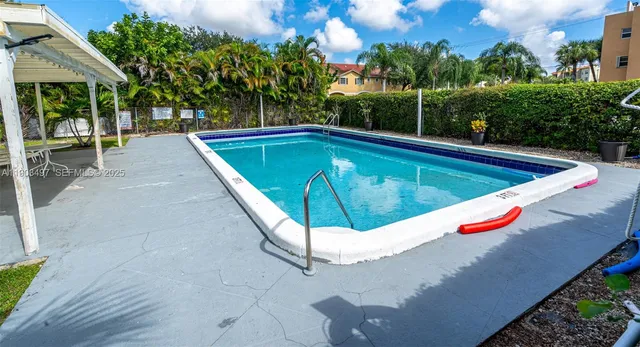 a view of a backyard with sitting area