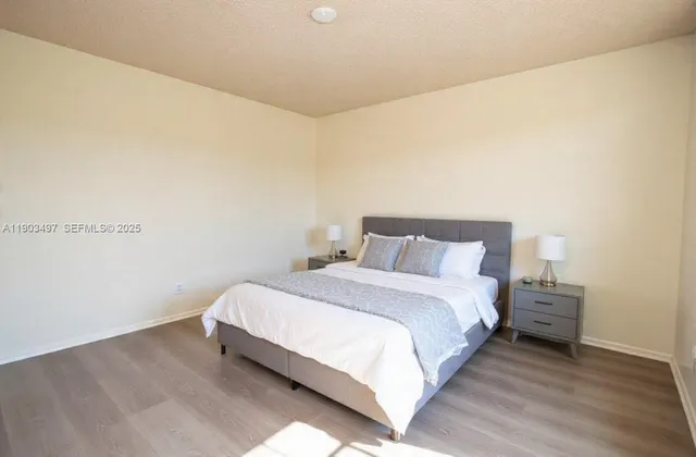 a bedroom with a bed and a night stand