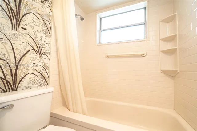 a bathroom with a bathtub and shower