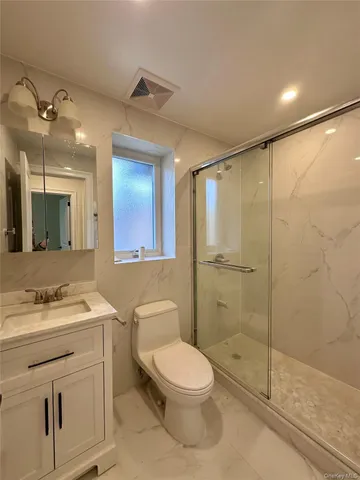 a bathroom with a toilet a sink and shower