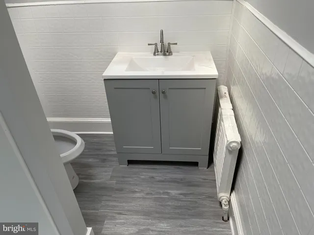 a bathroom with a sink a toilet and vanity