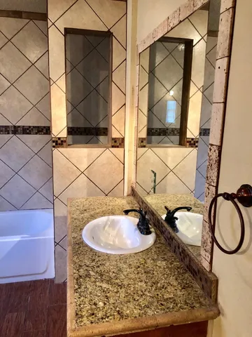 a bathroom with a sink and a mirror