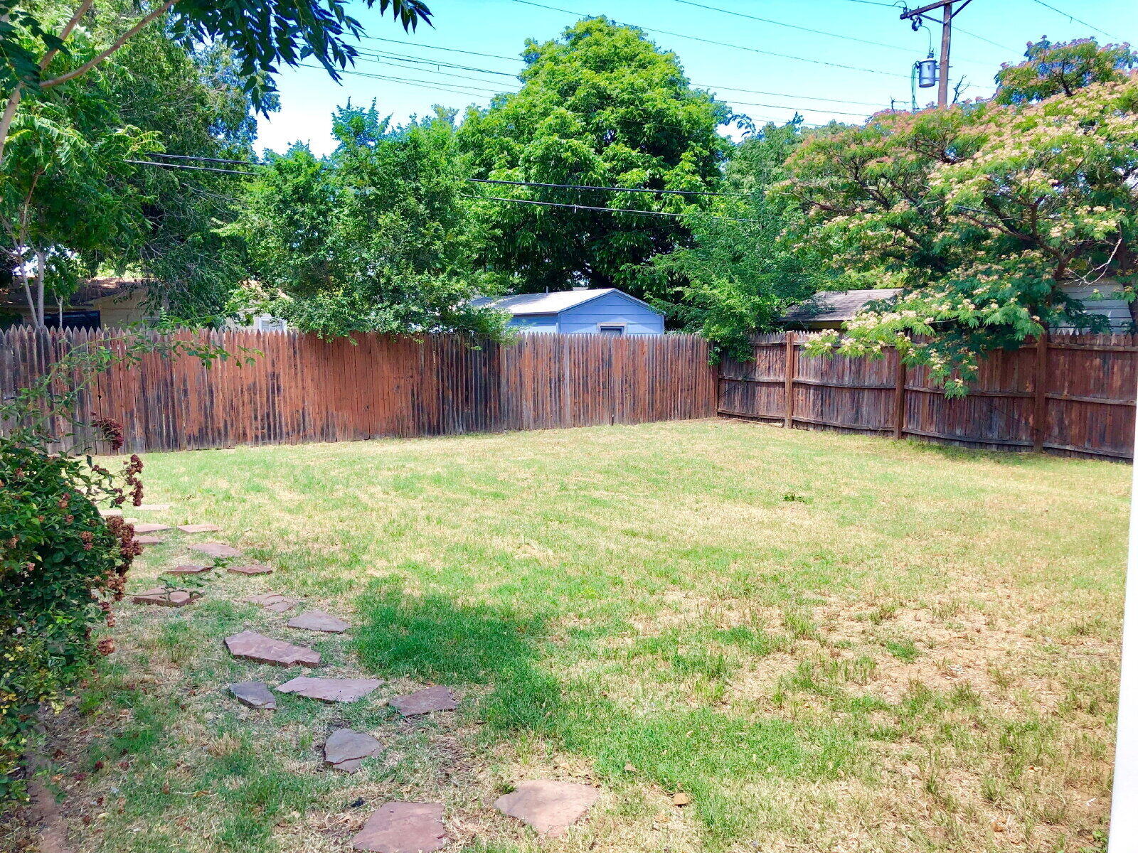 3412 30th Street Lubbock, TX 79410 - Photo 13 of 14 a swimming pool with wooden fence