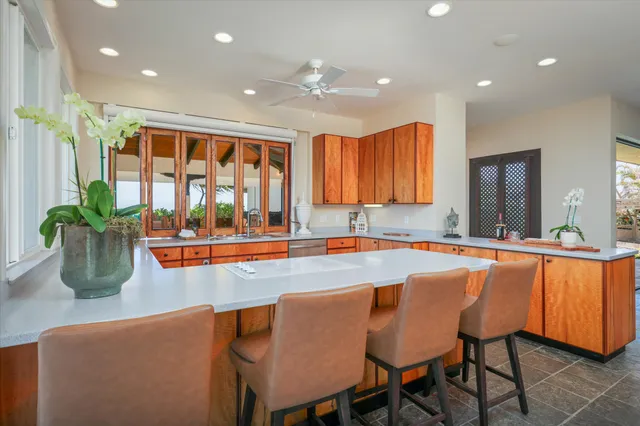 a dining hall with stainless steel appliances granite countertop a granite counter tops and a window