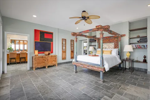 a bedroom with a bed and a chandelier