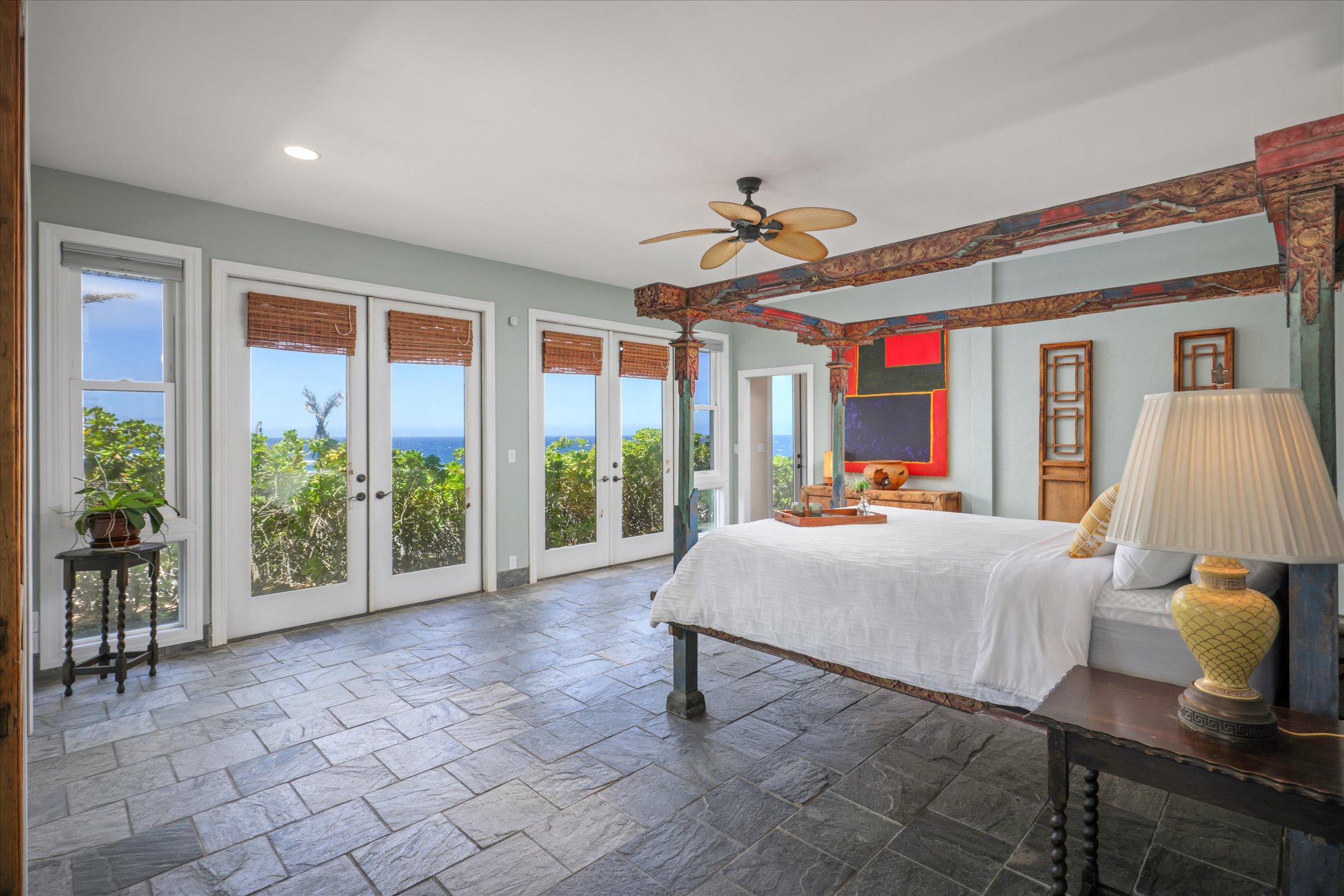 95-4667 Hawaii Belt Road Naalehu, HI 96772 - Photo 18 of 30 a bed room with a bed and a chandelier