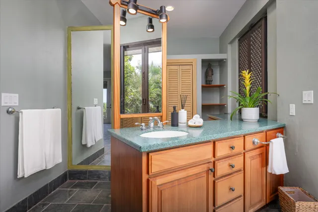 a bathroom with sinks a mirror and a shower