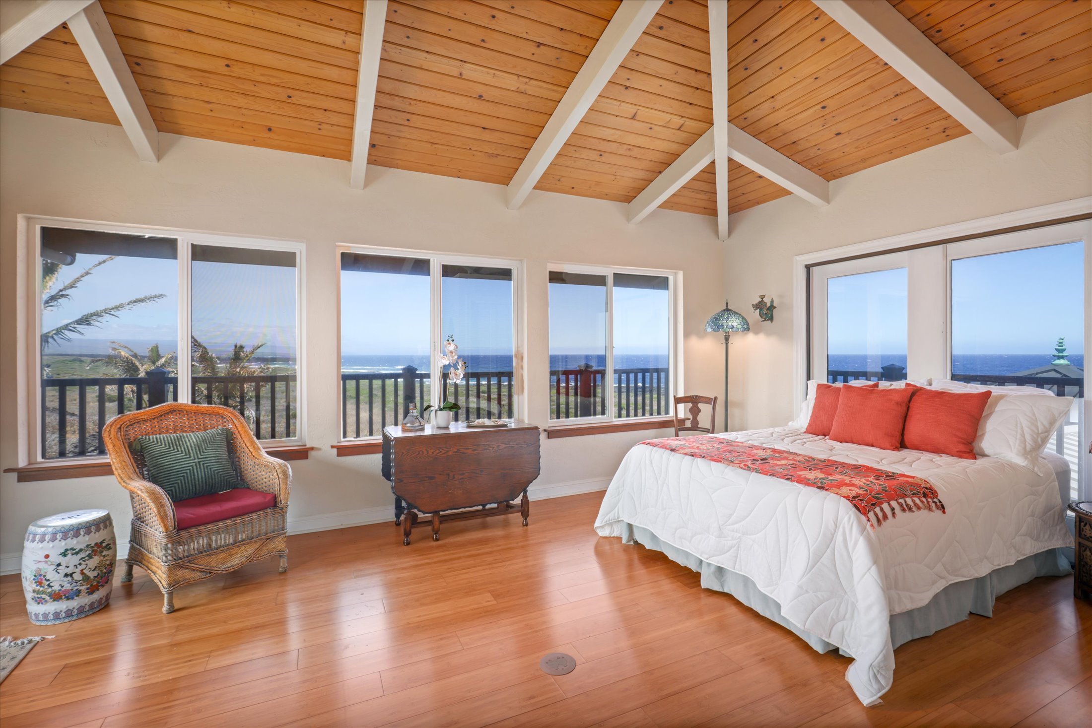 95-4667 Hawaii Belt Road Naalehu, HI 96772 - Photo 23 of 30 a bedroom with a bed and glass window