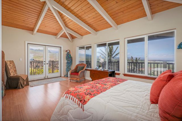 a bed room with a bed and a large window