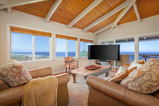 a bedroom with furniture and a flat screen tv