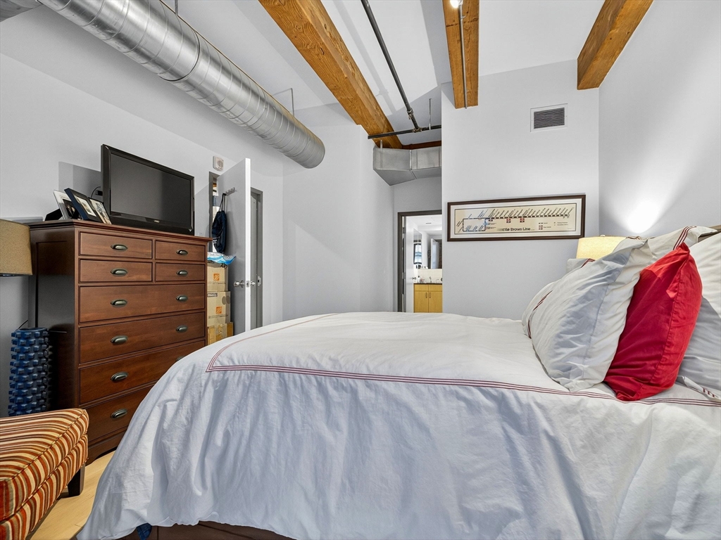9 West Broadway, Unit 206 Boston, MA 02127 - Photo 11 of 25 a bedroom with a bed and flat screen tv