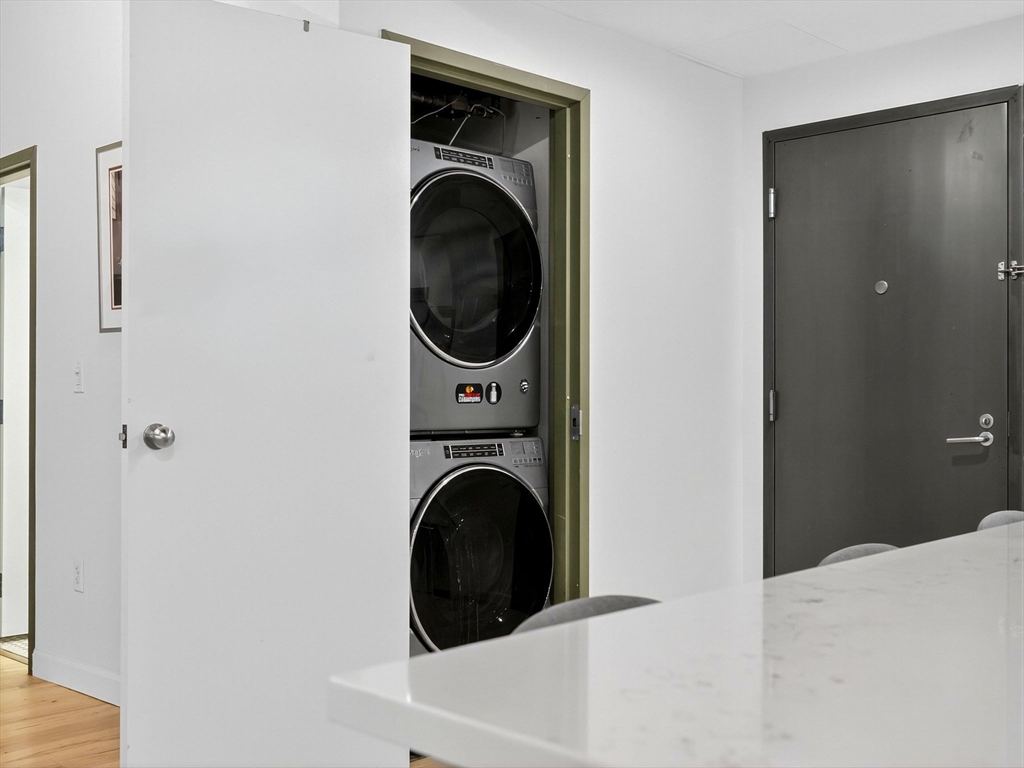 9 West Broadway, Unit 206 Boston, MA 02127 - Photo 13 of 25 a view of a hallway with washer and dryer