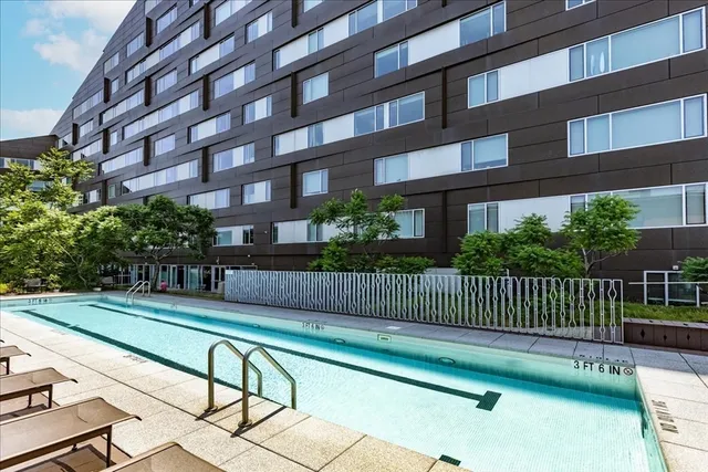 a view of a building with a bench next to a yard