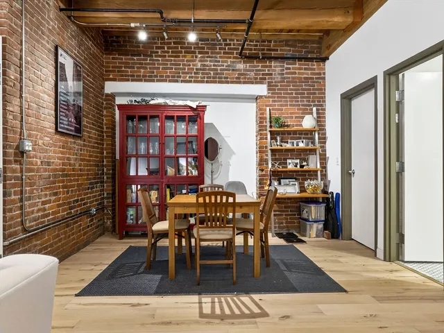 a dining room with furniture and wooden floor