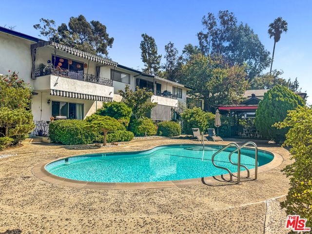 a front view of a house with a yard table and chairs