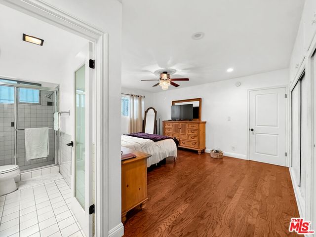 a view of a bedroom with a bed and glass door