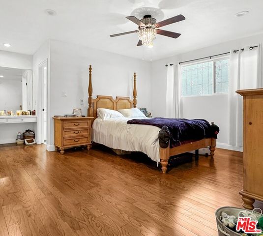 a spacious bedroom with a bed and a chandelier