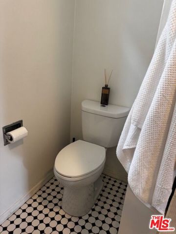 a white toilet sitting next to a shower curtain