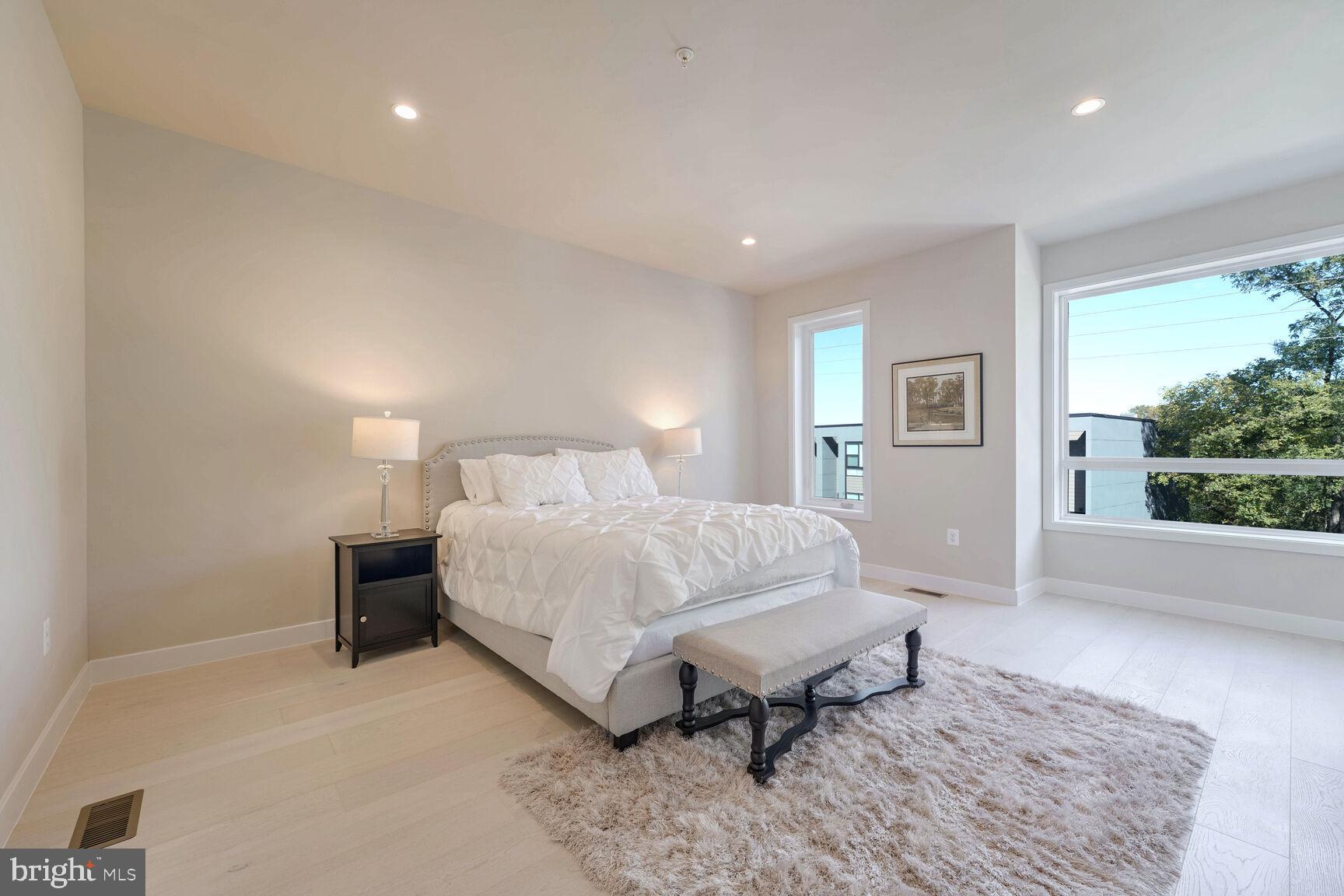 2514 Elvans Road Southeast Washington, DC 20020 - Photo 14 of 25 a bedroom with a bed lamp on table and a large window