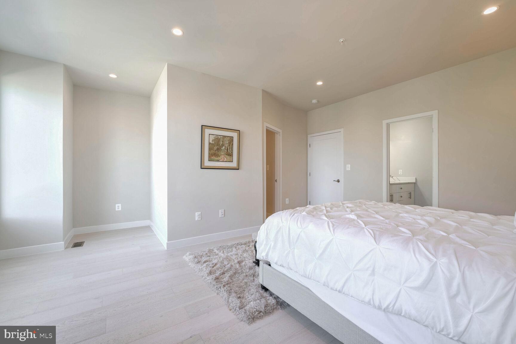 2514 Elvans Road Southeast Washington, DC 20020 - Photo 15 of 25 a spacious bedroom with a bed and a painting