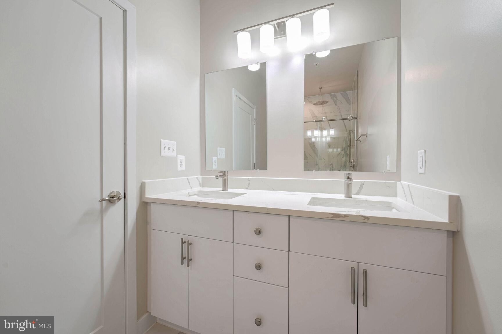 2514 Elvans Road Southeast Washington, DC 20020 - Photo 18 of 25 a bathroom with a double vanity sink and a mirror