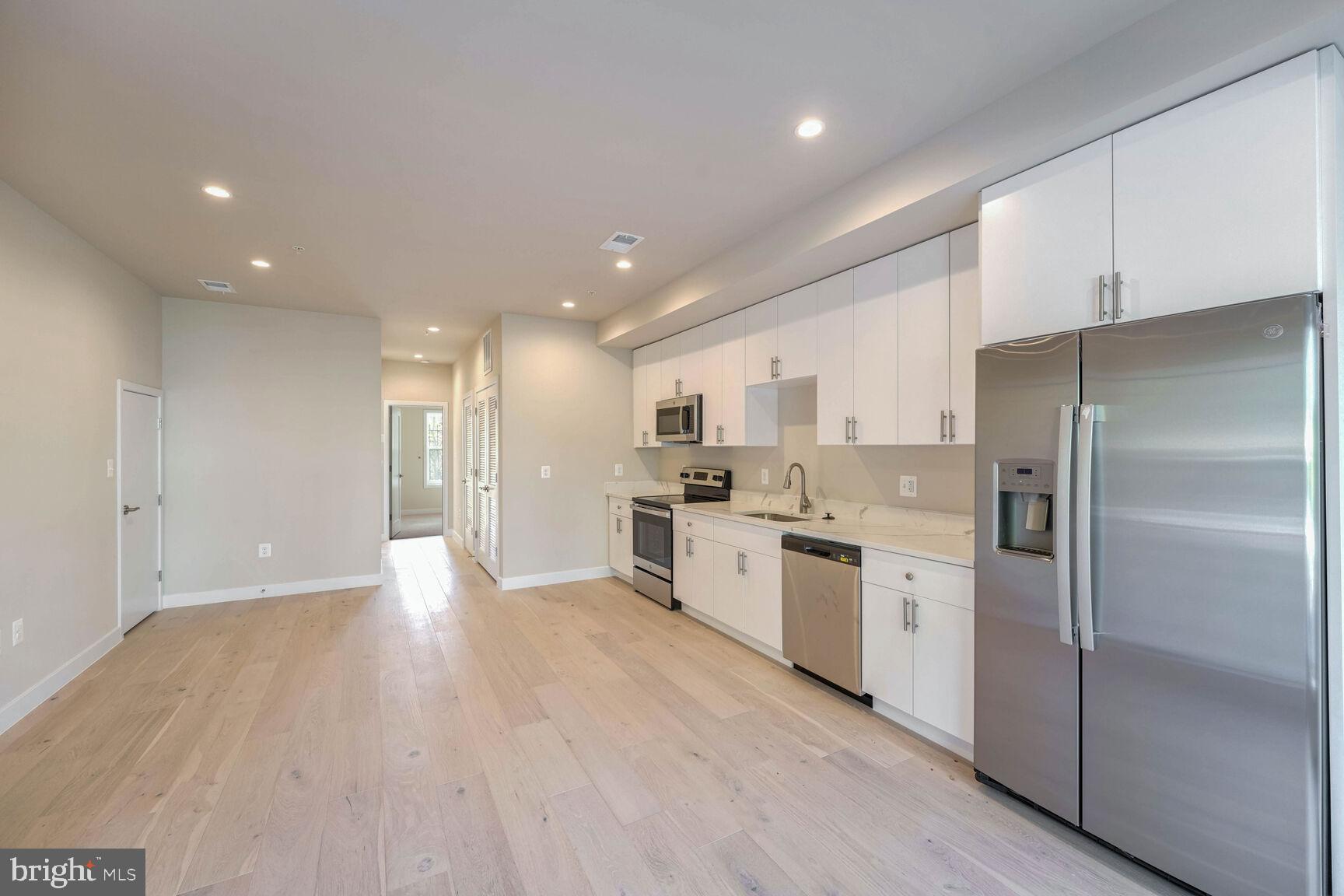2514 Elvans Road Southeast Washington, DC 20020 - Photo 22 of 25 a large kitchen with a lot of counter top space stainless steel appliances and a window