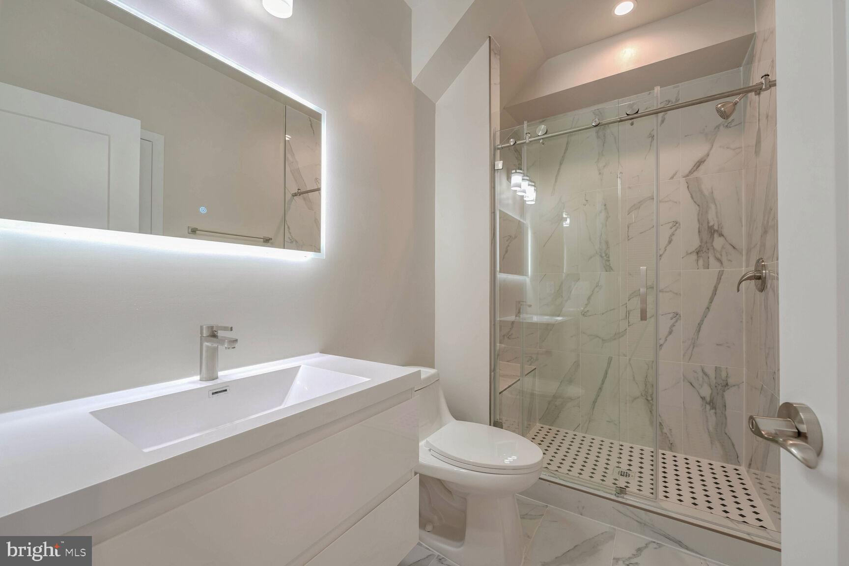 2514 Elvans Road Southeast Washington, DC 20020 - Photo 24 of 25 a bathroom with a sink a toilet and shower
