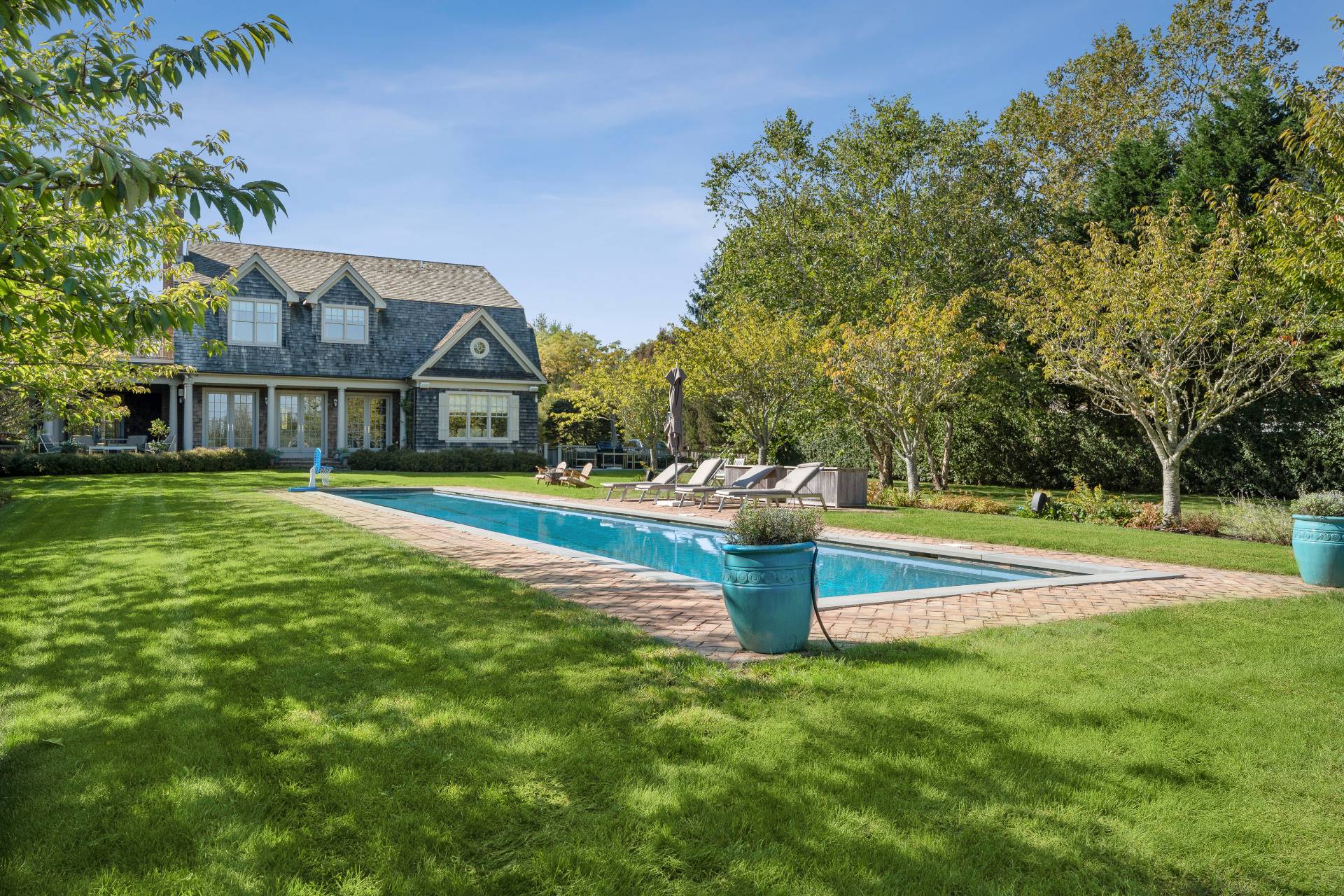 25 Jordan Drive Water Mill, NY 11976 - Photo 4 of 43 a view of swimming pool with lawn chairs and large trees