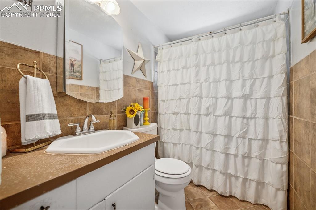 6771 Boone Road Boone, CO 81025 - Photo 46 of 49 a bathroom with a granite countertop sink and a mirror