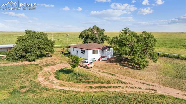 a kitchen with stainless steel appliances kitchen island granite countertop a table chairs and a refrigerator