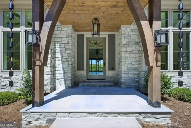 a view of an entryway with floor to ceiling windows