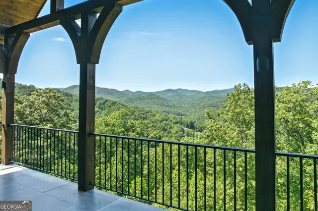 a view of an empty room with a window and a ceiling fan