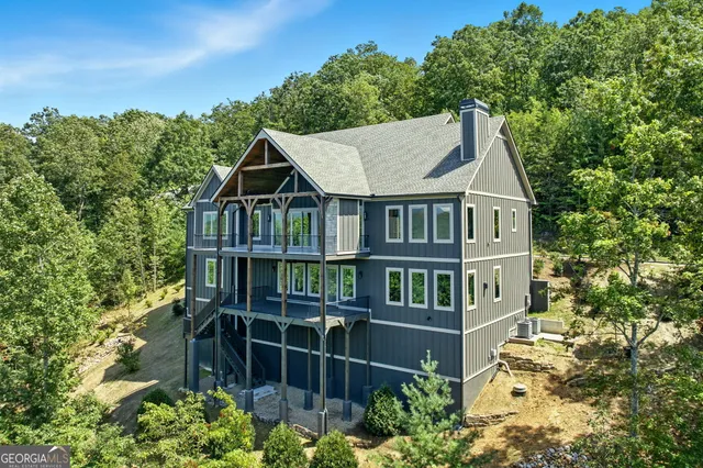 an empty room with windows and ceiling fan