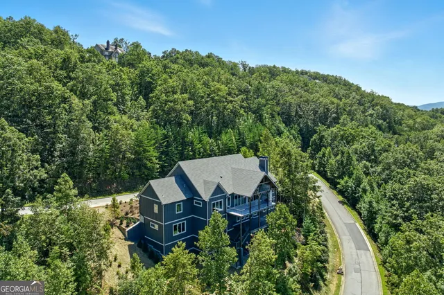 a view of empty room with wooden floor and ceiling fan