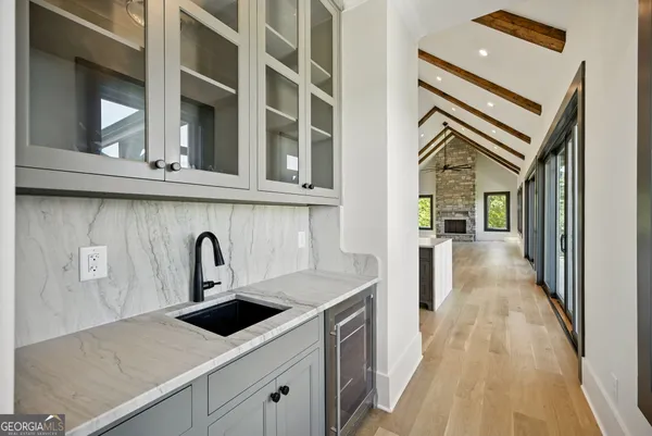a view of empty room with wooden floor and fireplace