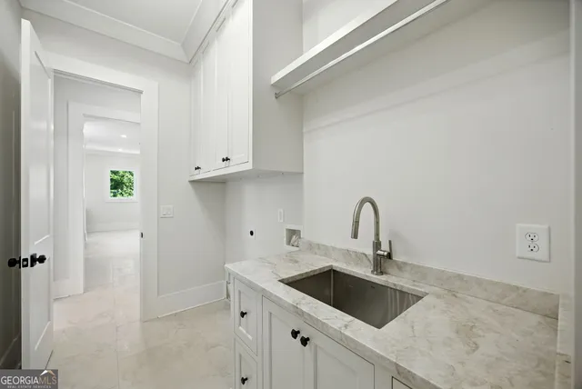 a bathroom with a granite countertop toilet a sink and a window