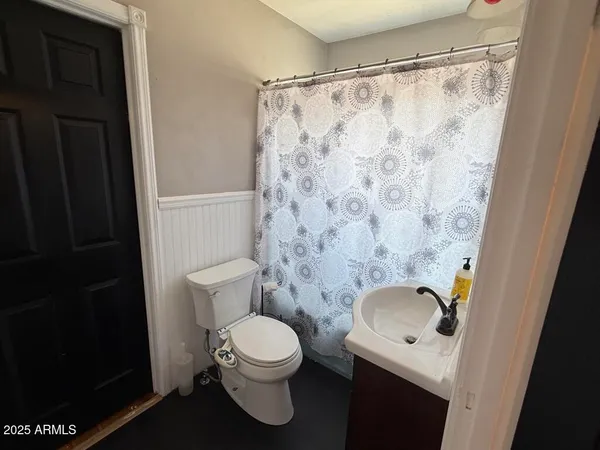 a bathroom with a toilet and a shower