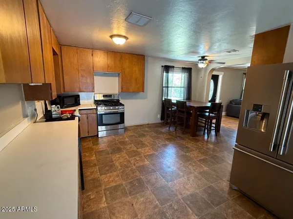 a kitchen with stainless steel appliances a stove refrigerator sink and cabinets