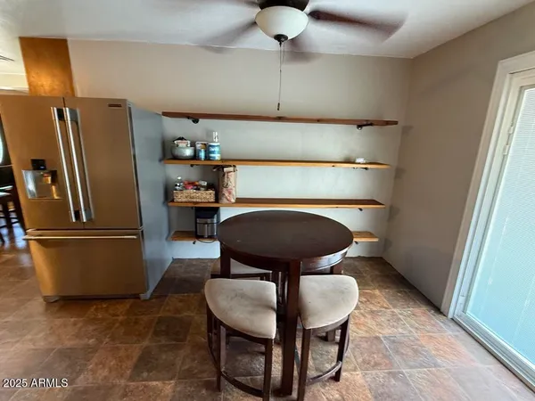 a kitchen with a refrigerator a microwave a stove and cabinets