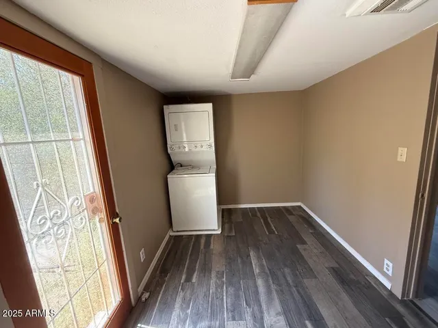 a front view of a house with a large tree