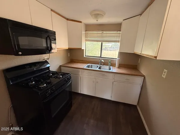 a kitchen with a sink a refrigerator and window