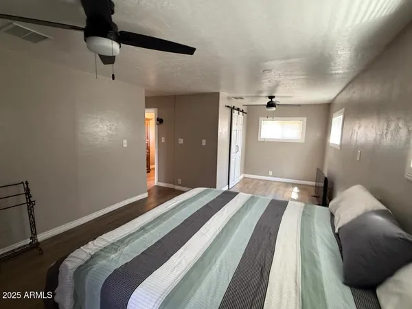a bedroom with a bed and a chandelier