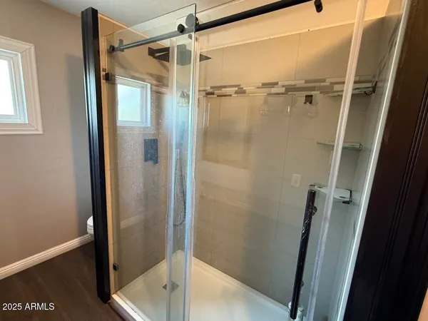 a bathroom with a glass door shower