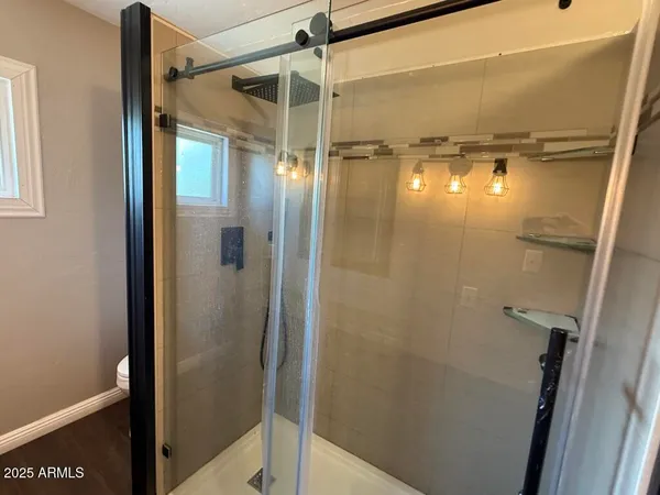 a bathroom with a glass door shower