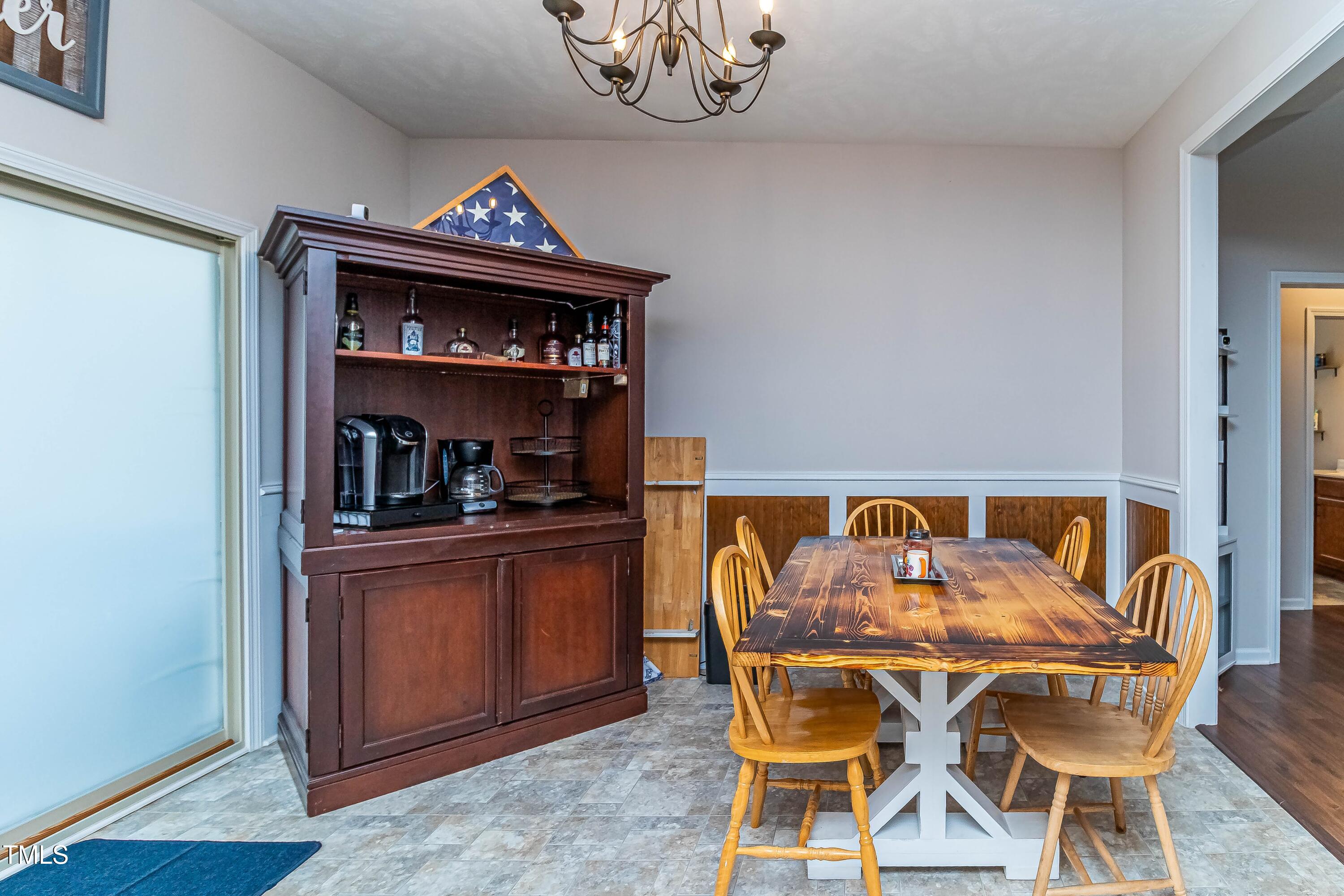 1852 Alderman Mill Road Dunn, NC 28334 - Photo 15 of 36 a view of a dining room with furniture and wooden floor