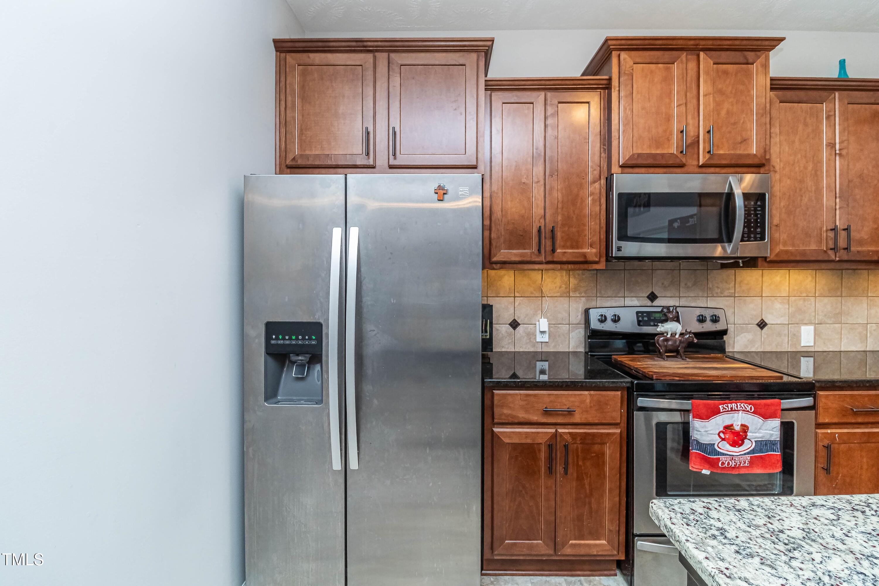 1852 Alderman Mill Road Dunn, NC 28334 - Photo 16 of 36 a kitchen with stainless steel appliances granite countertop a refrigerator stove and sink